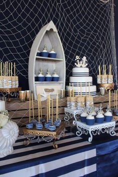 a table topped with lots of cakes and cupcakes