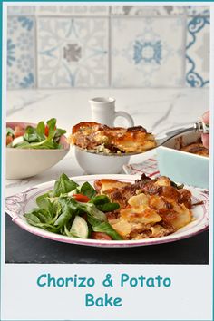 a white plate topped with food next to a bowl of salad