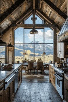 an open kitchen and dining room with mountain view