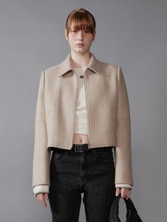 This is a semi-cropped jacket crafted from a wool blend, offering a soft and warm touch with exuding a formal mood.- Semi-oversized fit allowing for various stylings- Features a front zipper closure, adding a casual flair- The jacket's silhouette exuding a minimalistic mood Elegant Cropped Beige Outerwear, Elegant Beige Cropped Outerwear, Chic Wool Cropped Jacket For Fall, Winter Workwear Cropped Jacket With Zipper Closure, Winter Cropped Jacket For Workwear With Zipper Closure, Modern Cropped Jacket With Zipper For Work, Modern Cropped Jacket With Zipper Closure For Work, Chic Cropped Wool Jacket, Cropped Jacket With Zipper For Work