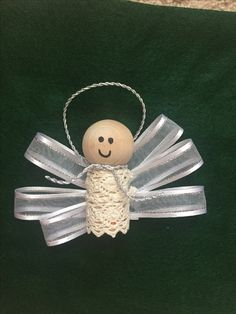 an angel ornament with a smiling face on it