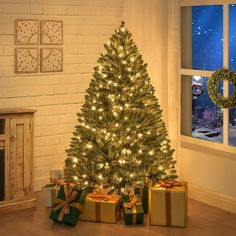 a decorated christmas tree in front of a window