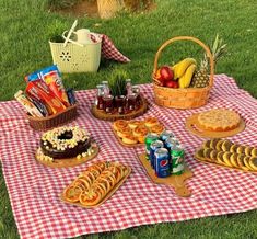 a picnic blanket with food and drinks on it