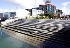 an empty stadium stands next to the water