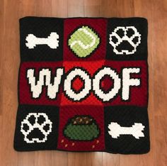 a crocheted afghan with the words woof on it