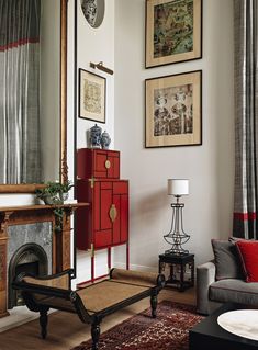 a living room filled with furniture and pictures on the wall