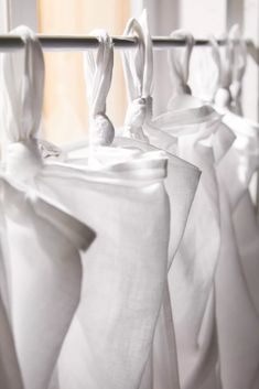 some white curtains hanging up in a room