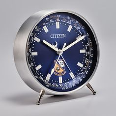 a close up of an analog clock on a white background with the word citizen printed on it