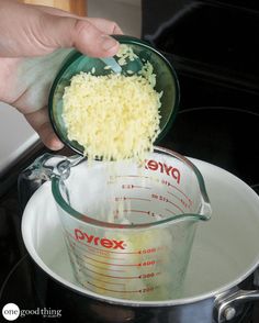 someone is adding rice into a measuring cup