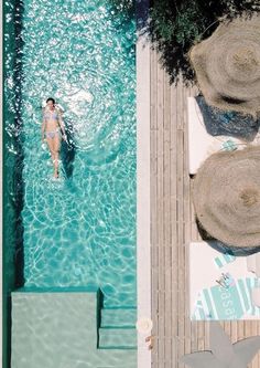 an aerial view of a woman swimming in a pool