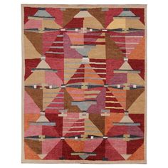 a multicolored rug with different shapes and colors on it, including red, orange,