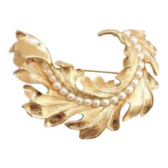 This is part of Chairish’s Costume Jewelry assortment.  1960s goldtone 3d leaf with line of faux-pearls down the center brooch with security clasp. Marked "Napier." 2 1/4 inches long by 3 inches wide. Excellent condition. An identical brooch is shown on pg. 339 of Melinda L. Lewis & Henry Swen's book "The Napier Co.: Defining 20th Century American Costume Jewelry."  Please reference the measurements noted in the description above for the best approximate dimensions. Please reach out to the selle Nolan Miller Jewelry, American Costume, Leaf Brooch, Jewelry Boards, Edwardian Fashion, Modern Branding, Decorative Elements, Ethnic Jewelry, Favorite Pins