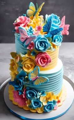 a multi - layered cake decorated with flowers and butterflies