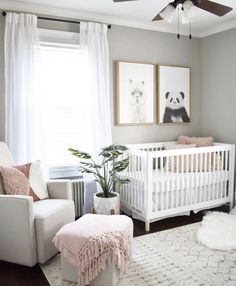 a baby's room with a white crib, pink and gray decor and pictures on the wall