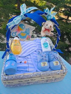 a baby boy gift basket with blue shoes and booties