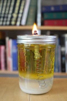 a jar filled with liquid sitting on top of a wooden table