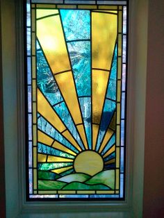 a stained glass window with the sun in it