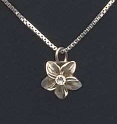 Lovely vintage silver tone metal pendant in the shape of a flower, set with a round cut colorless cubic zirconia. The pendant is set on a vintage Italian sterling silver box link chain necklace. Pendant 5/8 x 7/16" 1.2g UNMARKED Chain 24 inches long 3.3g Marked "925 ITALY" Silver Flower-shaped Jewelry With Diamond Cut, Silver Diamond Necklace With Flower Charm, Silver Flower Diamond Jewelry, Silver Flower Pendant Necklace With Diamond Cut, Silver Diamond Jewelry With Flower Charm, Silver Flower Charm Necklace With Round Pendant, Silver Flower Necklace With Round Pendant For Anniversary, Silver Flower Necklace For Anniversary, Formal Silver Necklace With Flower Charm