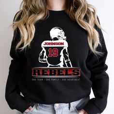 This sweatshirt can be customized with your school colors and mascot, along with the player's name and number.  Perfect for cold game nights. Please refer to the sizing chart in the photo.  For an oversized sweatshirt, choose one at least 2-3 sizes larger that you would normally wear For more school spirit apparel, click here: https://www.etsy.com/shop/JLsTshirts?ref=seller-platform-mcnav&section_id=36596774 All other tshirts... https://www.etsy.com/shop/JLsTshirts * Adult Unisex Sweatshirt, Gildan  * Soft, comfortable feel * 50% cotton, 50% polyester * Medium-heavy fabric * Runs true to size, but please check the size chart in pictures.    NO RETURNS OR EXCHANGES ... these shirts are printed just for you after you place your order. Machine wash, warm.  Tumble dry: medium heat; Iron, steam Team-colored Football Season Sweatshirt, Team-colored Sweatshirt For Football Season, Team-colored Football Season Fan Sweatshirt, Team-colored Crew Neck Hoodie For Game Day, Football Season Sweatshirt In Team Colors With Team Name, Collegiate Football Season Sweatshirt With Team Name, College Football Season Sweatshirt With Team Name, Collegiate Football Season Sweatshirt, Team-colored Sweatshirt With Team Logo For Fans