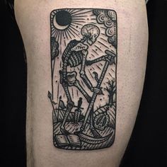 a black and white tattoo on the leg of a man