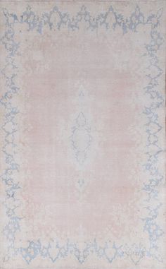 an antique rug with blue and pink colors