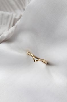 a close up view of a white shirt with a gold tie pin on it's lapel