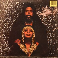 an album cover with a man and woman wearing headdress on their heads in front of snow flakes