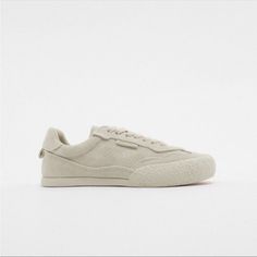 Casual Athletic Leather Sneakers. Textured Rubberized Toes. Back Pull Tab. Lace Closure. Sole Height: 0.8 Inches (2 Cm) Starfit. Flexible Technical Sole Made Of Polyurethane Foam Designed To Offer Increased Comfort. See Less Beige | 5675/010 Classic Suede Sneakers With Flat Heel, Classic Suede Flat Sneakers, Suede Sneakers With Vulcanized Sole, Beige Suede Sneakers With Flat Heel, Suede Sneakers With Red Sole And Round Toe, Suede Sneakers With Red Sole, Zara Low-top Sneakers With Contrast Sole, Zara Casual Sneakers With Textured Sole, Zara Casual Leather Sneakers