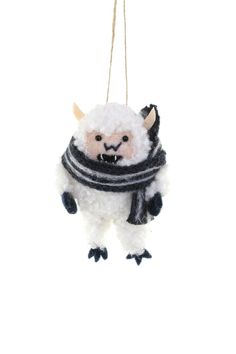 a white and black stuffed animal hanging from a string