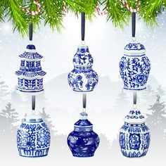 a group of blue and white vases hanging from a christmas tree with snow on the ground