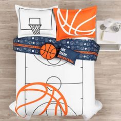 an overhead view of a bed with basketballs and hoop on the pillowcase,