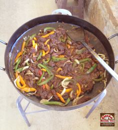 a skillet filled with beef and peppers