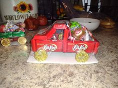 a red truck filled with candy sitting on top of a counter