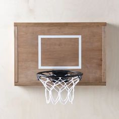 a basketball hoop mounted to the side of a wooden wall with a white net on it