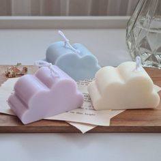 three soaps sitting on top of a wooden tray