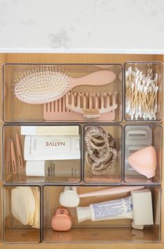 an organized drawer filled with beauty products and brushes, soaps, toothbrushes, and other personal care items