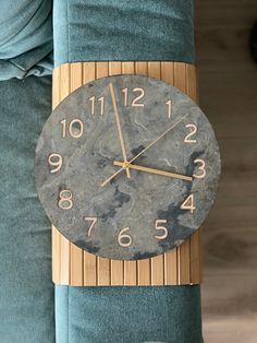 a clock that is on the side of a couch