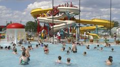 many people are in the water at an amusement park