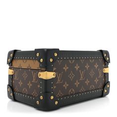 a louis vuitton purse with gold hardwares and rivets on the front