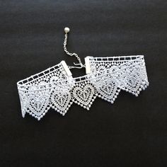 "A lovely heart patterned scalloped lace is linked with silver accents in this choker style necklace.  Wonderful accent piece for the bride or bride to wear and be a special keepsake gift.  The lace measures 1 1/2\" at widest point and the first link closes at 12 1/2\" neck measurement.  With extension chain the choker will adjust to 14 1/2\" measurement and there is a wire wrapped pearl bead dangle on the chain.  Adjustments can be made to length of choker depending on availability of materials White Lace Choker, Wire Wrapped Pearl, Lace Choker Necklace, Lace Choker, Choker Style Necklace, Lace Necklace, Wedding Accessory, Necklace Heart, Choker Style