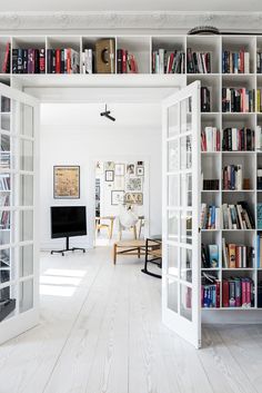 an open door leading to a living room filled with books