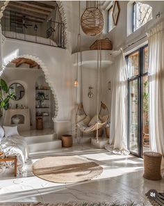 a living room filled with lots of furniture and decor on top of a white floor