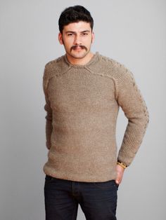 a man with a mustache wearing a sweater