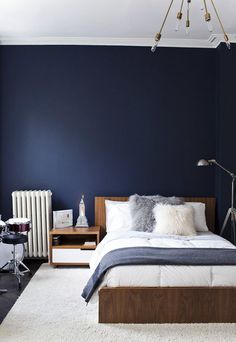 a bedroom with blue walls and white carpet