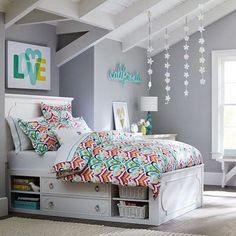 a bedroom with gray walls and white furniture