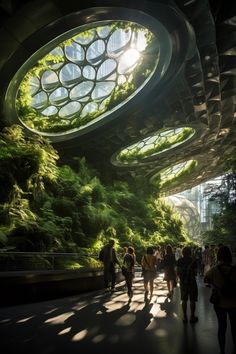 people are walking through an indoor area with green plants on the walls and large circular windows