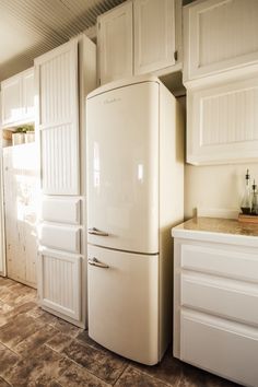 a white refrigerator freezer sitting inside of a kitchen