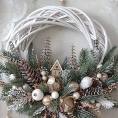 a christmas wreath with pine cones and ornaments