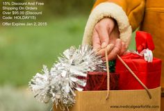 a person holding wrapped presents in a brown box with silver tinsel on the top