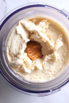 a blender filled with ice cream and peanut butter on top of a white counter